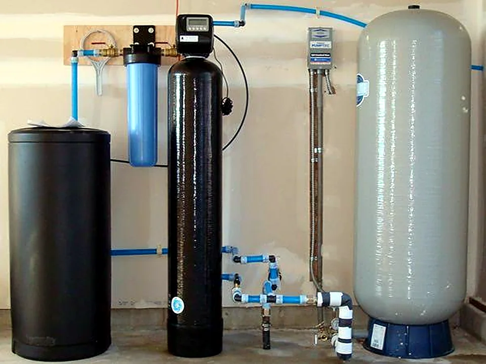 A water treatment install with a softener, filter housing, UV unit and pressure tank