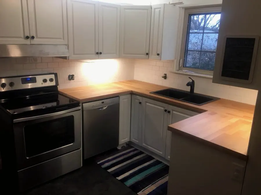 Kitchen with a new sink and faucet under a window