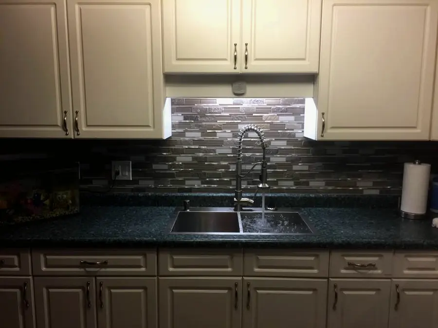 Double kitchen sink with a pull-down faucet
